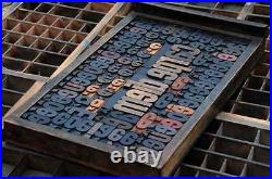 Collage CARPE DIEM made of letterpress wood type characters in antique drawer