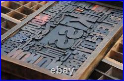 Collage KISS made of letterpress wood type characters in antique drawer old